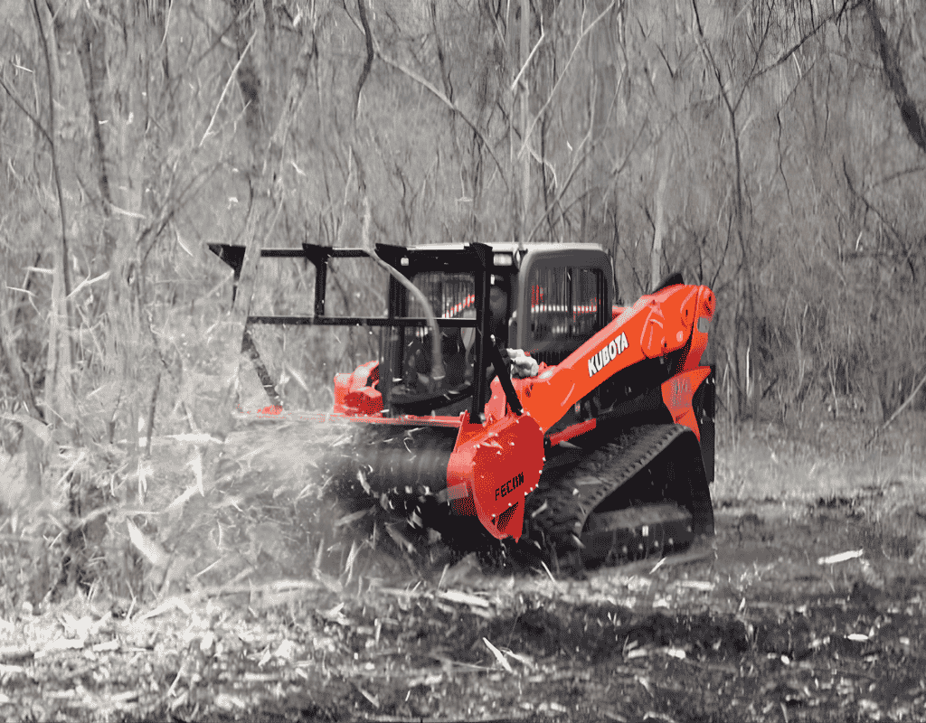 skid steer forestry mulcher grinding brush and trees in wooded area Wagoner County OK