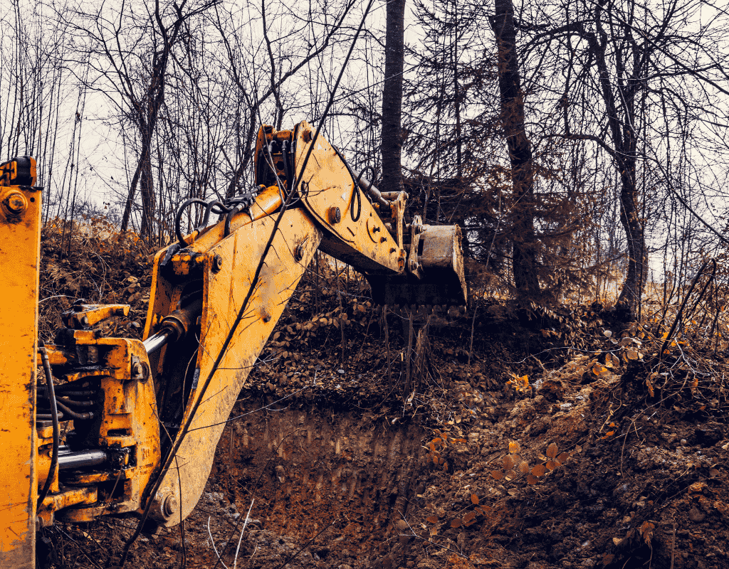 skid steer forestry mulcher grinding brush and trees in wooded area Wagoner County OK