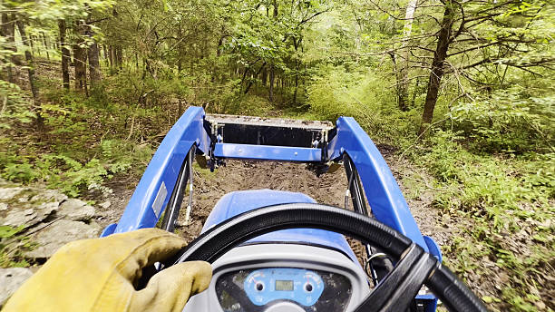 Forestry mulching equipment clearing thick brush around a rural Wagoner property entrance